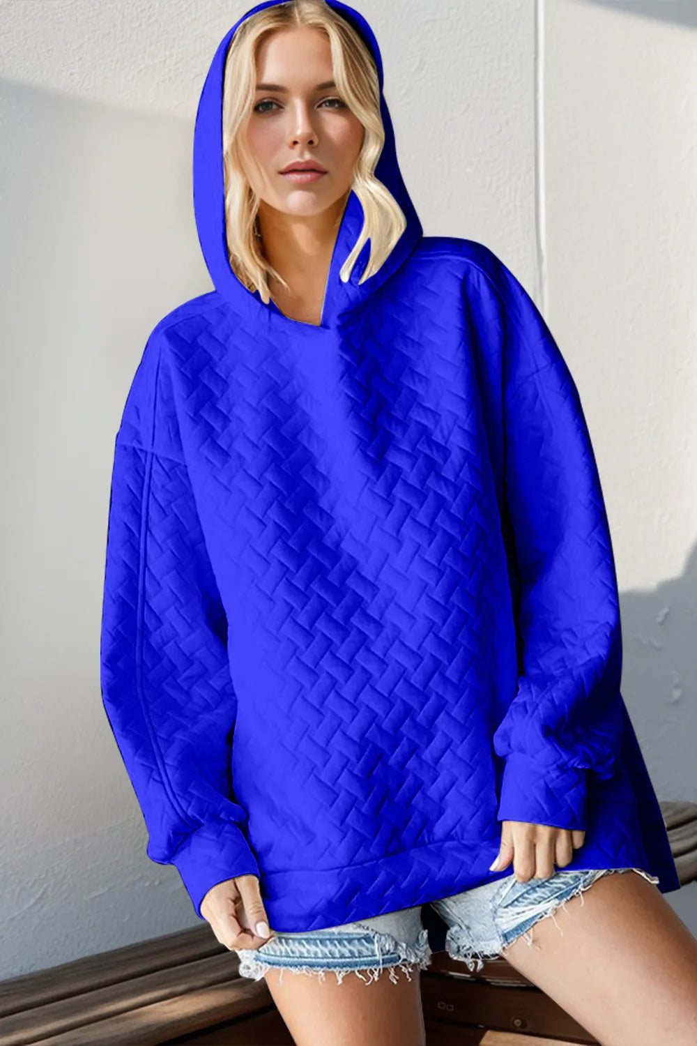 Black double take full size textured drop shoulder long sleeve hoodie by Trendsi, featuring a relaxed fit and soft fabric.