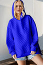 Black double take full size textured drop shoulder long sleeve hoodie by Trendsi, featuring a relaxed fit and soft fabric.