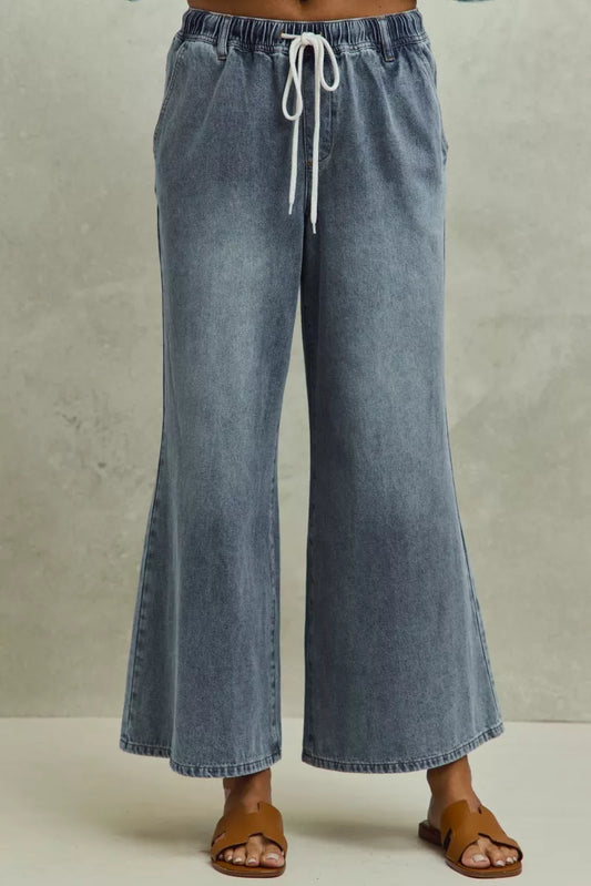 Mid-rise elastic waist flare denim jeans by Trendsi, featuring classic blue wash and stylish flare leg design.