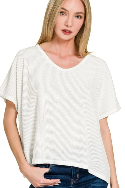 Ribbed V-neck short-sleeve knit top by Trendsi, featuring a fitted design and textured fabric in a neutral color.