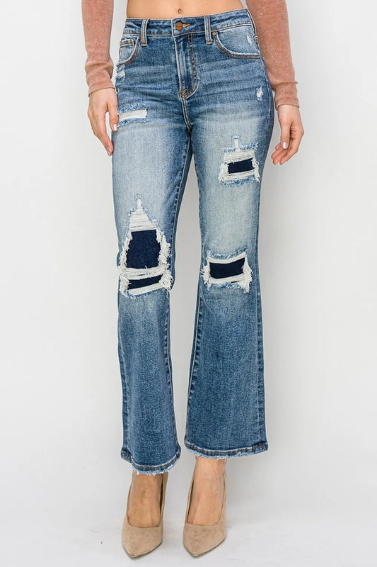 Risen full size high-rise distressed ankle flare jeans featuring a fitted waist and frayed hem, styled with casual top and accessories.