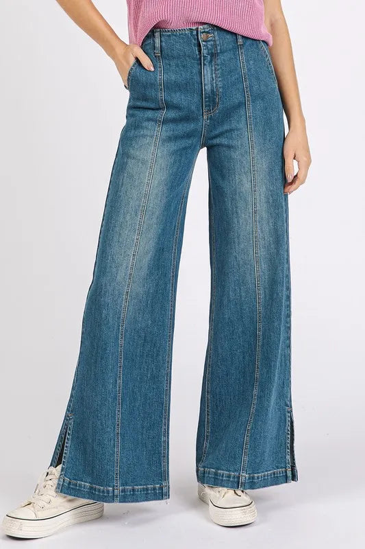 Medium wash wide-leg denim jeans by Mittoshop with seam detail, showcasing a relaxed fit and classic style.