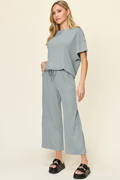 Trendsi Double Take full size textured round neck short sleeve T-shirt and wide-leg pants, showcasing a casual, comfortable outfit.