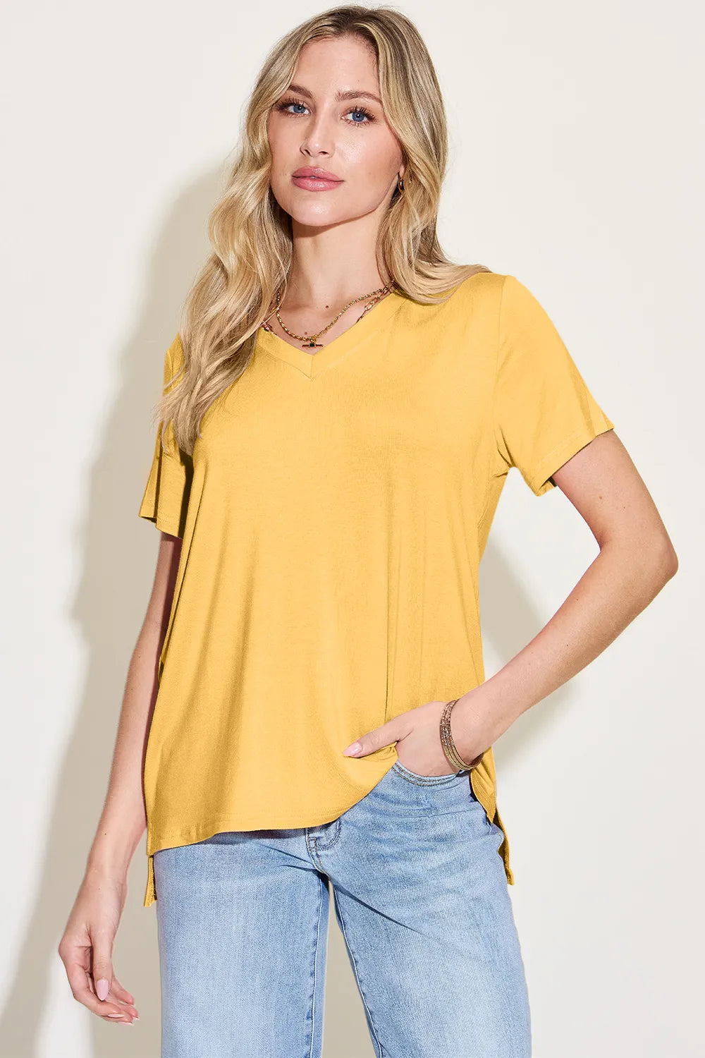 Basic Bae Bamboo V-Neck High-Low T-Shirt by Trendsi, showcasing the full-size bamboo fabric t-shirt with a V-neck and high-low hem design.