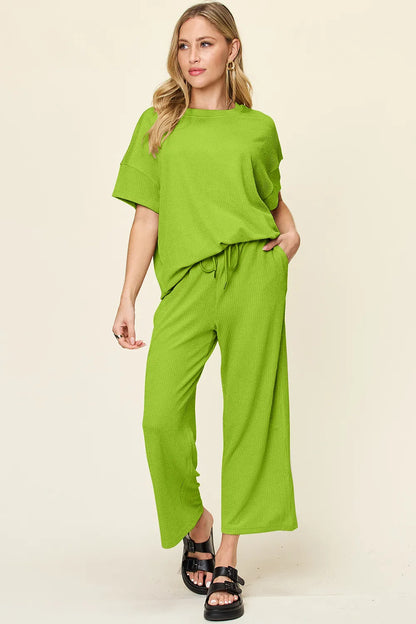 Trendsi Double Take full size textured round neck short sleeve T-shirt paired with wide-leg pants, casual and stylish outfit.