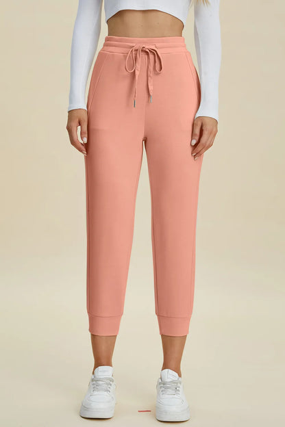 Trendsi Basic Bae full-size air scuba drawstring high waist cropped pants in black, with a relaxed fit and stretchy fabric.