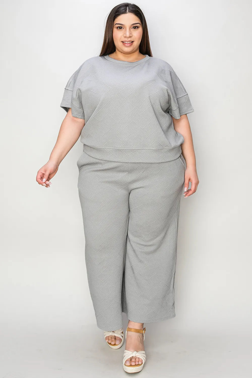 Trendsi Double Take full size textured short sleeve top and matching pants set displayed on a model, casual fashion ensemble.