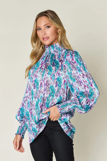 Long sleeve smocked blouse with printed design from Trendsi, featuring a full size, stylish and comfortable for casual wear.