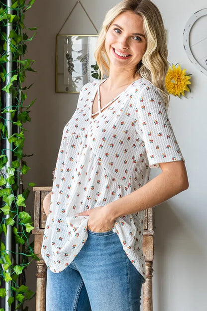 Heimish full size crisscross ditsy floral babydoll top with plus size fit, featuring a feminine floral pattern and lightweight fabric.