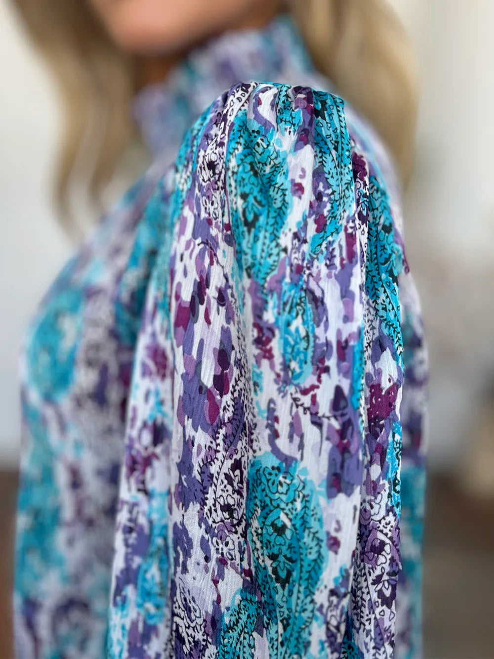 Printed smocked long sleeve blouse from Trendsi featuring a flattering fit and full size design, perfect for stylish casual wear.