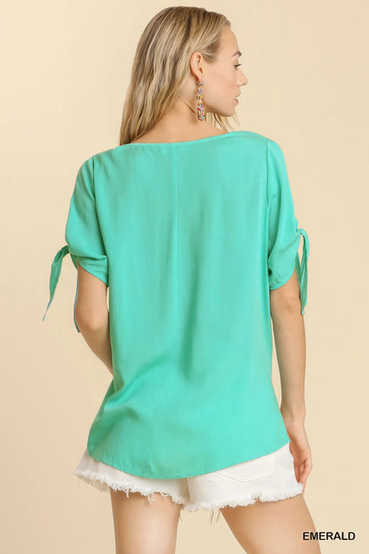 Trendsi Umgee cold shoulder short sleeve top with round neck, side slits, and tie knot details, shown flat with fabric texture visible.