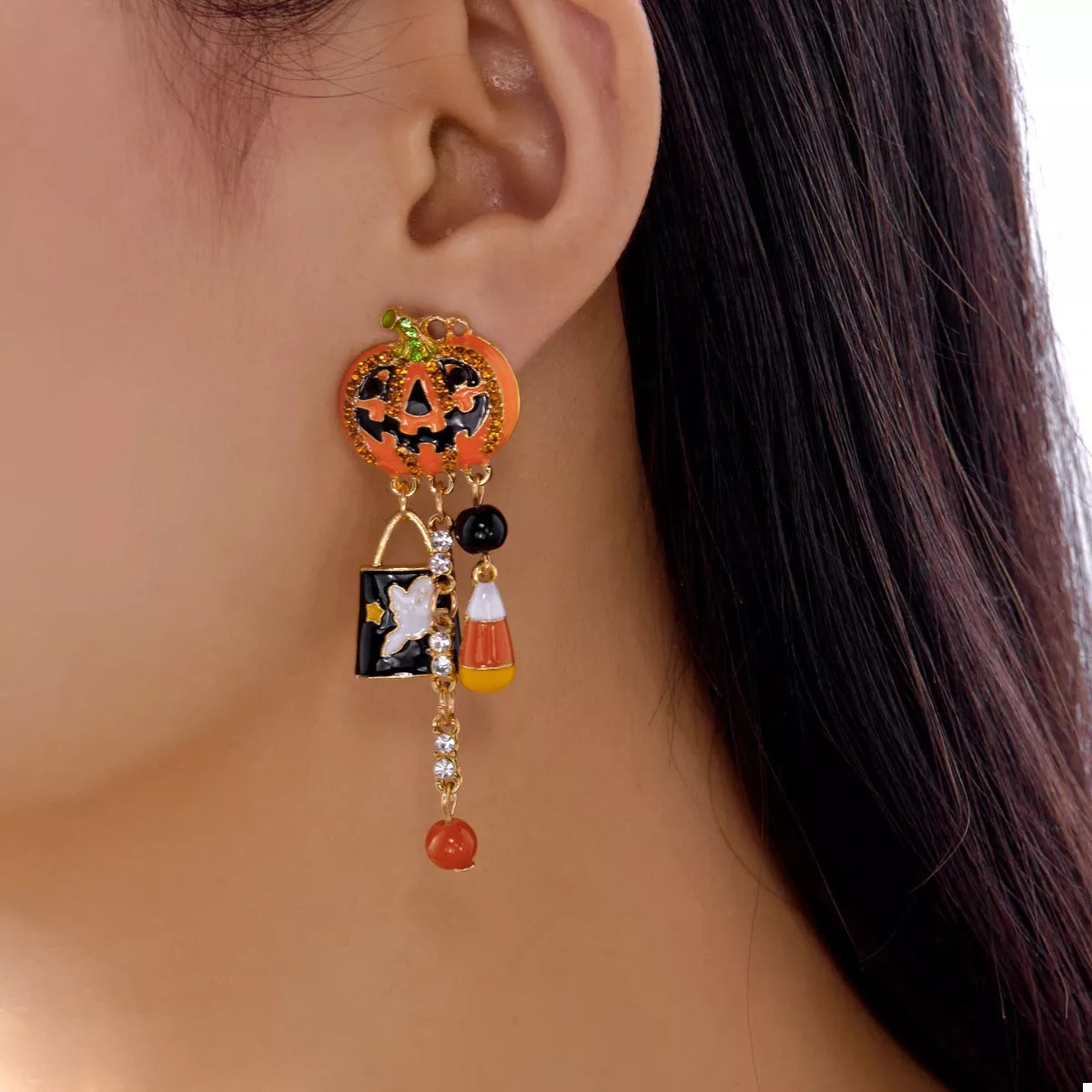 Halloween pumpkin drop earrings featuring orange pumpkin charms with black accents, perfect for festive fall accessorizing.