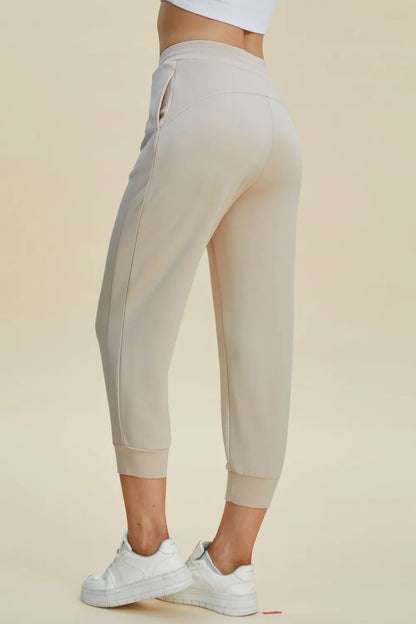 Trendsi Basic Bae full size air scuba drawstring high waist cropped pants in black fabric with elastic waistband and relaxed fit.