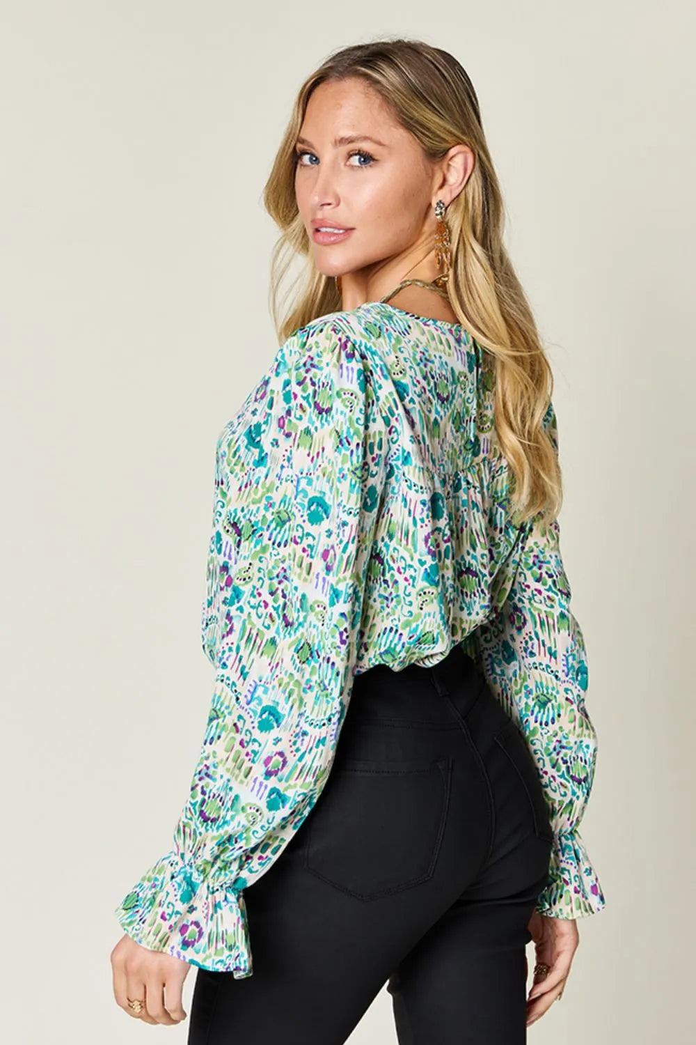 Printed flounce sleeve blouse by Trendsi, featuring a stylish full-size design with ruffled sleeves and vibrant pattern.