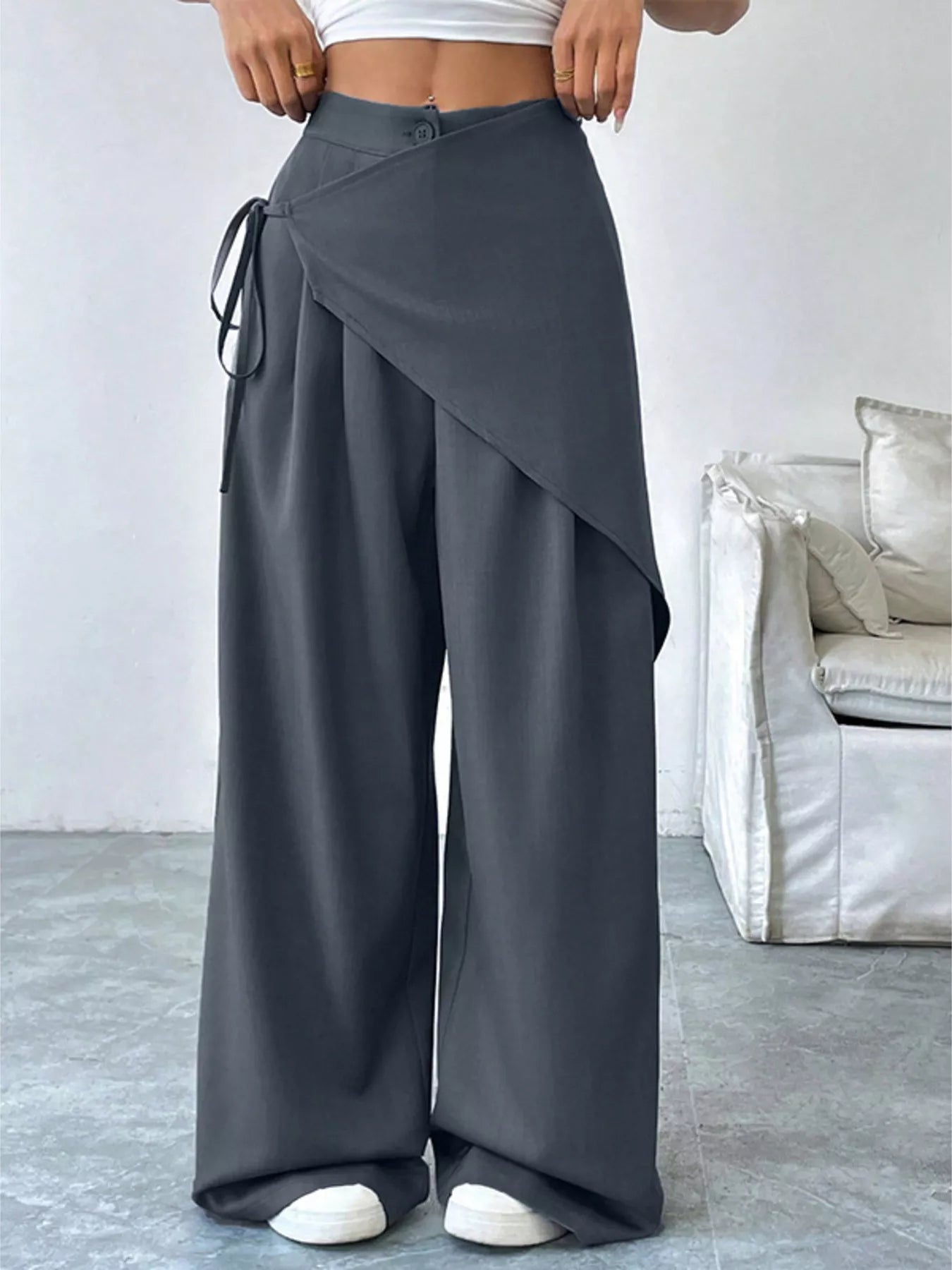 Gray asymmetrical wrap wide-leg pants by Trendsi, featuring a loose fit and stylish drape, shown on a mannequin.