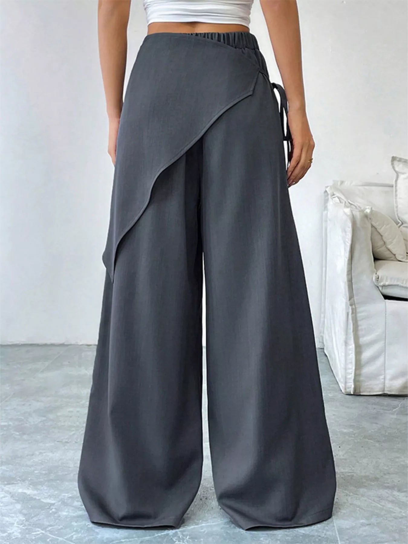 Gray asymmetrical wrap wide-leg pants from Trendsi, featuring a stylish, flowy design and a modern silhouette.
