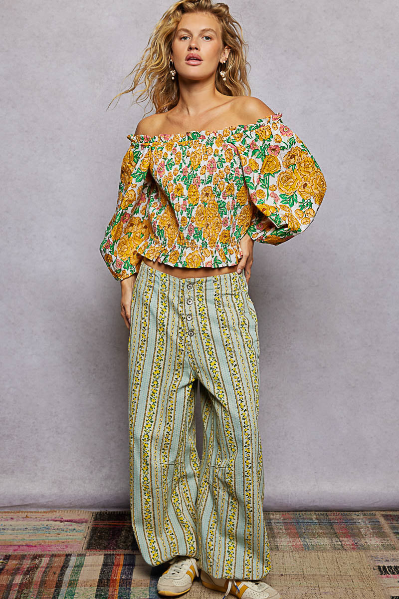 Honey-colored floral print off-shoulder smocked blouse by Trendsi, featuring ruffled neckline and long sleeves.