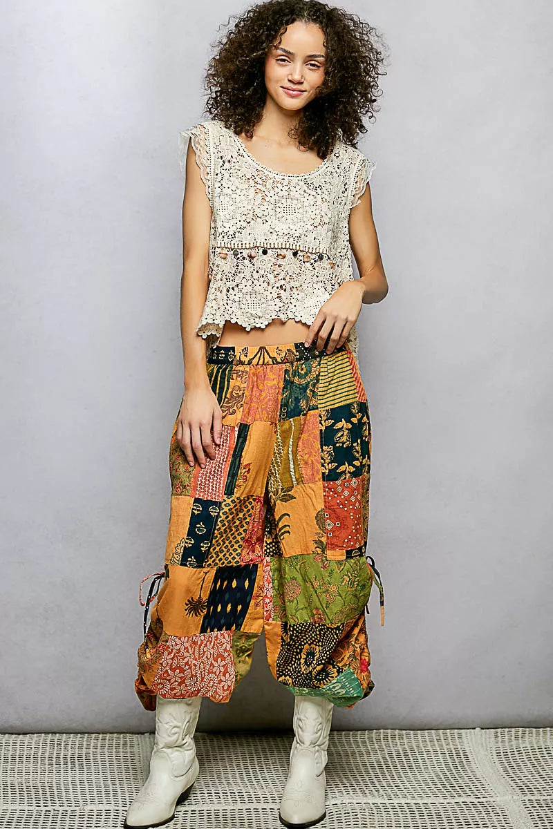 Honey multi-print patchwork wide-leg pants with adjustable side drawstring from Trendsi, showcasing relaxed fit and colorful design.