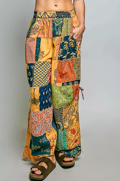 Honey-colored printed patchwork wide-leg pants from Trendsi with adjustable side drawstring and relaxed fit.