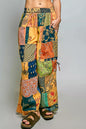 Honey-colored printed patchwork wide-leg pants from Trendsi with adjustable side drawstring and relaxed fit.