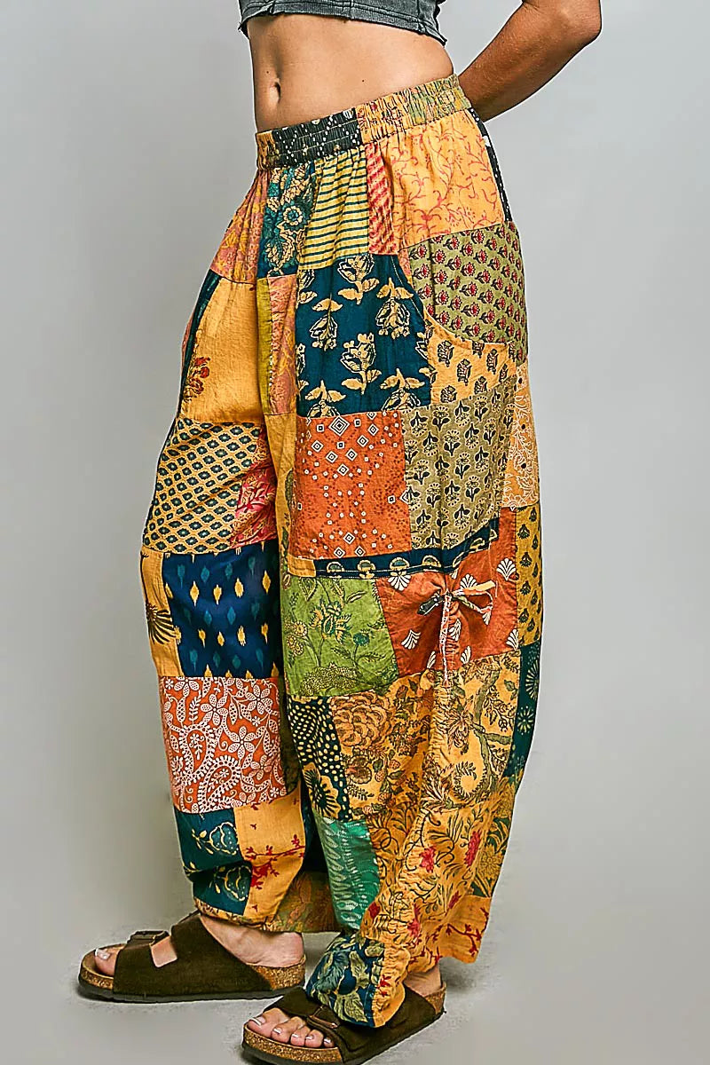 Honey-colored printed patchwork wide-leg pants from Trendsi with adjustable side drawstring and relaxed fit.