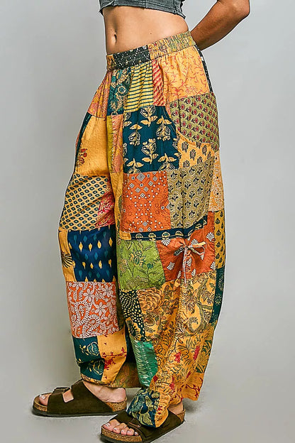 Honey-colored printed patchwork wide-leg pants from Trendsi with adjustable side drawstring and relaxed fit.