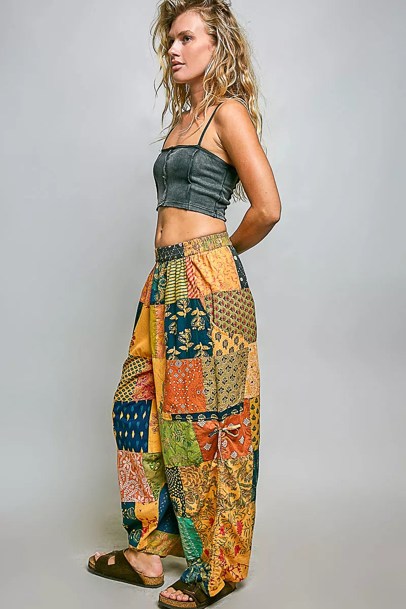 Honey-colored printed patchwork wide-leg pants with adjustable side drawstring from Trendsi, showcasing their relaxed fit and stylish design.