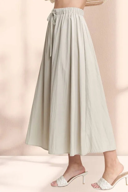 Khaki ADORA drawstring waist crinkle maxi skirt by Trendsi, flowing fabric with a relaxed fit and comfortable waist design.