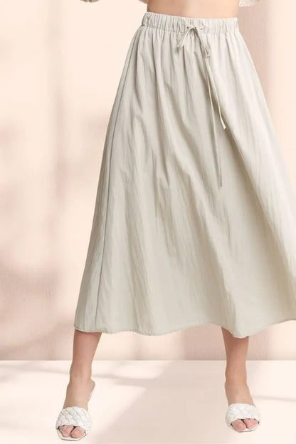 Khaki ADORA maxi skirt with drawstring waist, crinkle fabric, and flowing silhouette, perfect for casual or dressy looks.