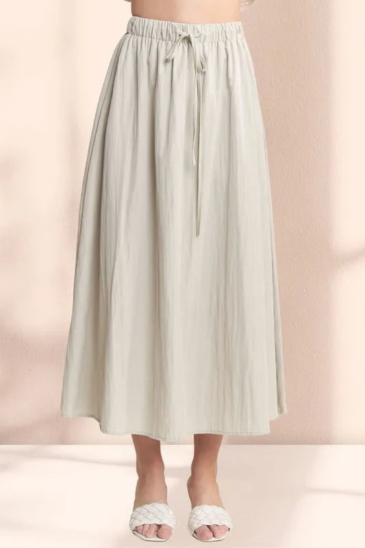Khaki ADORA drawstring waist crinkle maxi skirt from Trendsi, featuring a flowy design and comfortable elastic waistband.