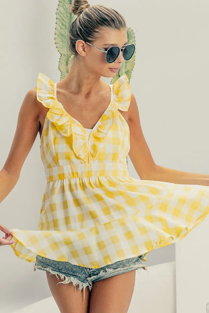 Lemon ivory sleeveless plaid peplum top with ruffled neckline from Trendsi, featuring check pattern and fitted silhouette.