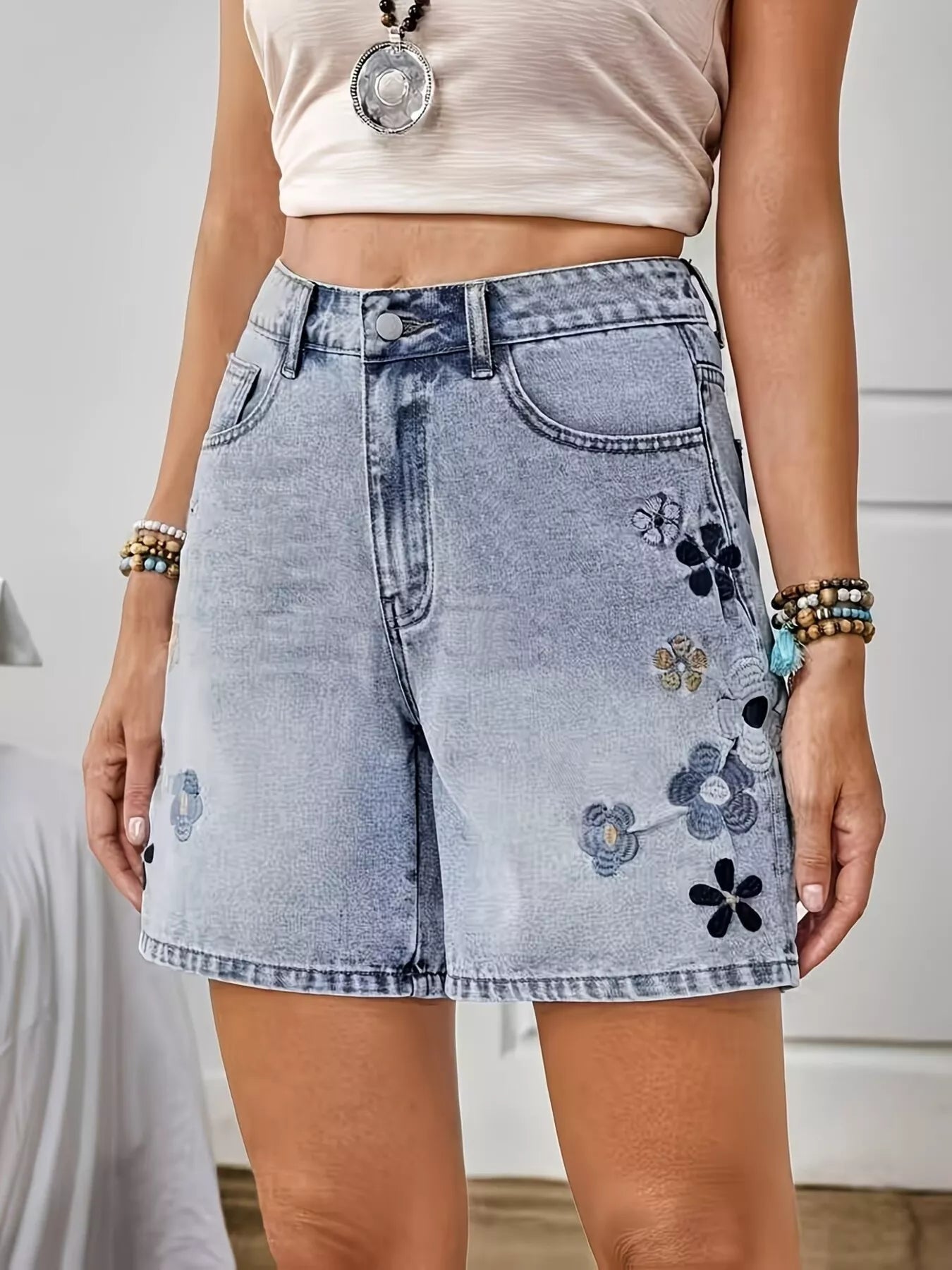 Light blue embroidered floral denim shorts with detailed floral embroidery, casual fit, by Trendsi.