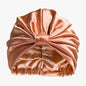 Organic silk hair bonnet in peachy coral from LINA LENNOX, designed to protect and gently cover hair during sleep.