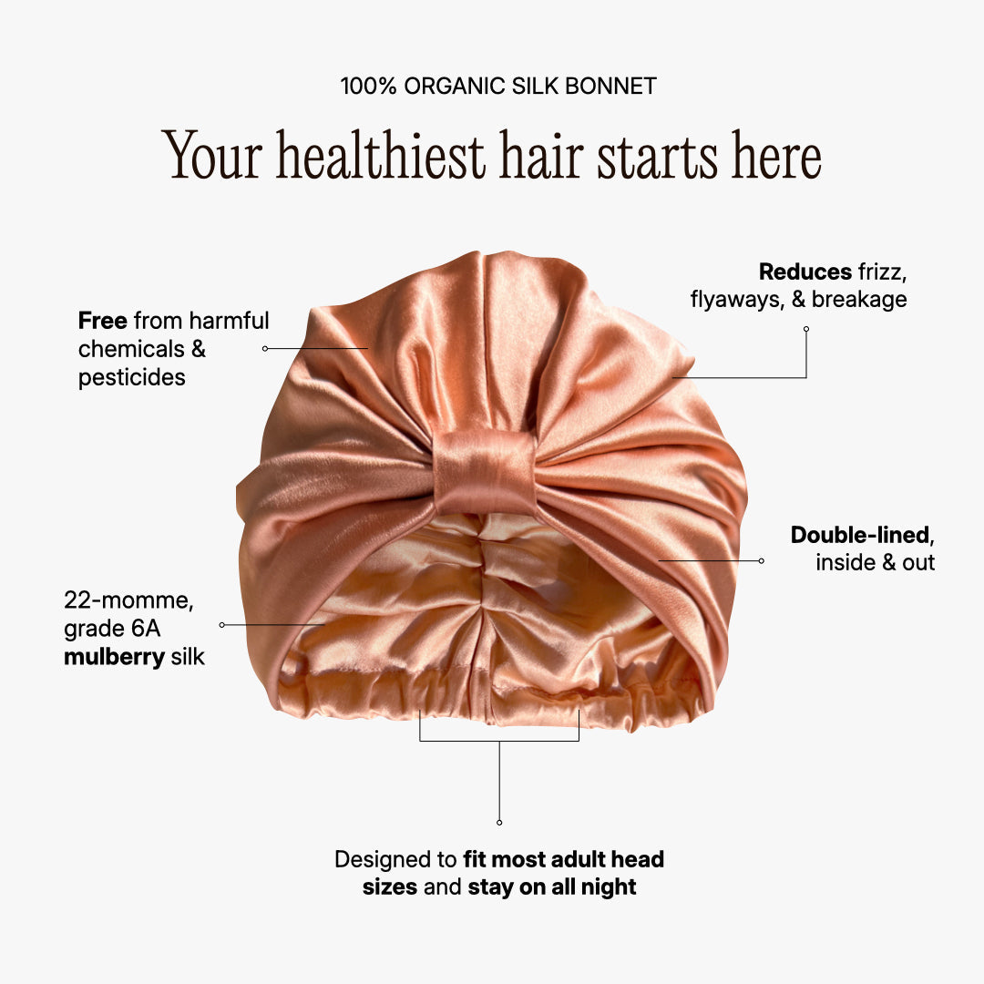 Organic silk hair bonnet in peachy coral by LINA LENNOX, showing the soft, smooth fabric and snug fit for hair protection.
