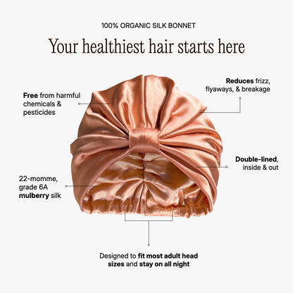 Organic silk hair bonnet in peachy coral by LINA LENNOX, showing the soft, smooth fabric and snug fit for hair protection.