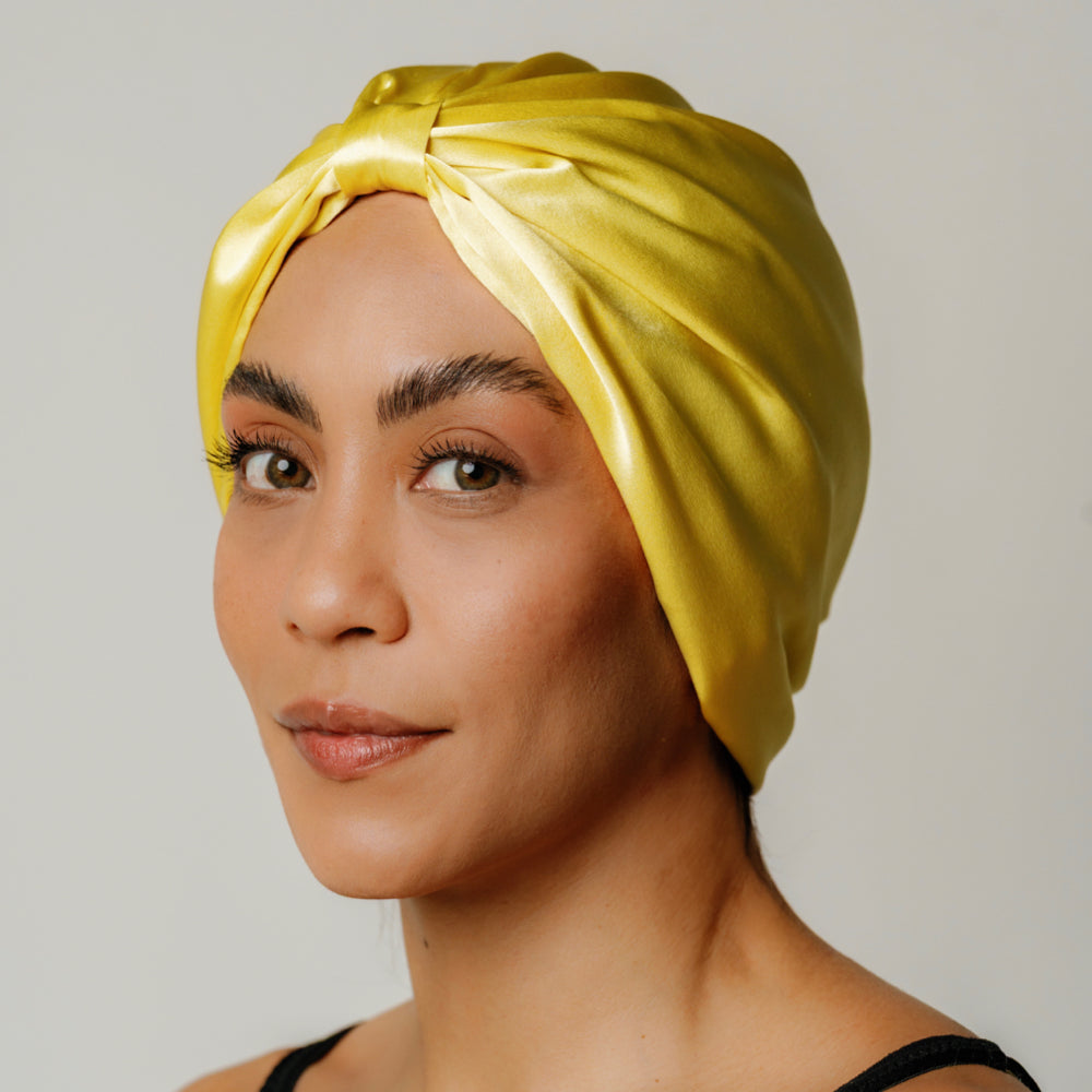 Sunshine yellow organic silk hair bonnet by LINA LENNOX, soft and comfortable sleep accessory with a smooth, shiny finish.