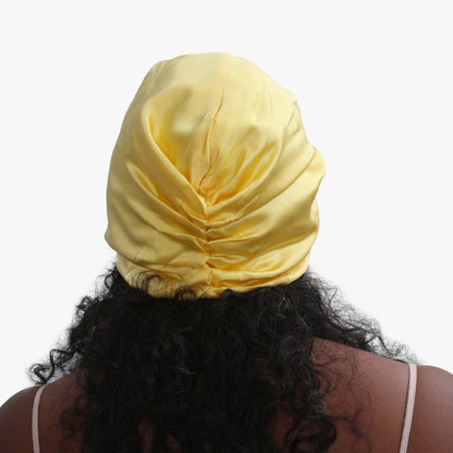 Sunshine yellow organic silk hair bonnet by LINA LENNOX, soft and smooth for gentle hair protection and style.