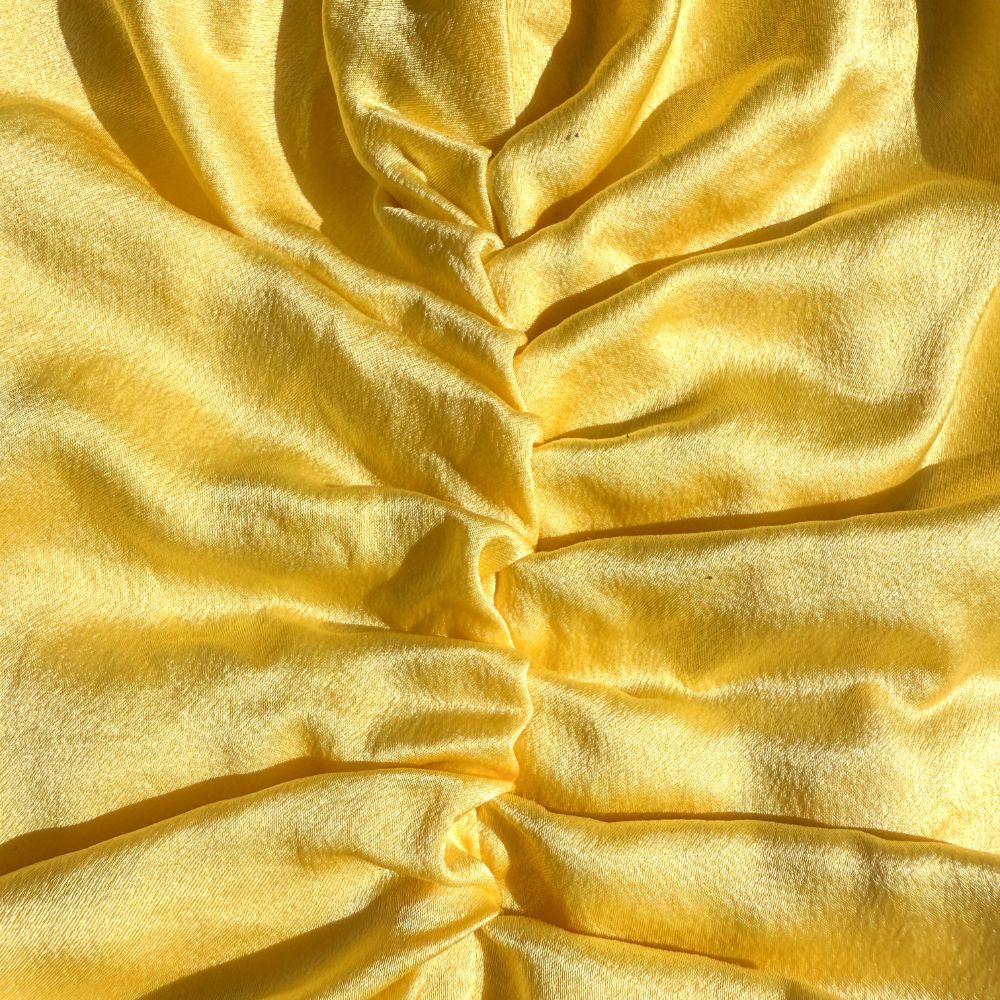 LINA LENNOX organic silk hair bonnet in bright sunshine yellow, soft and smooth for gentle hair protection.