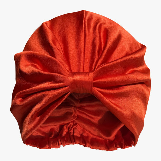 LINA LENNOX organic silk hair bonnet in vibrant tomato red, designed for gentle overnight hair protection.