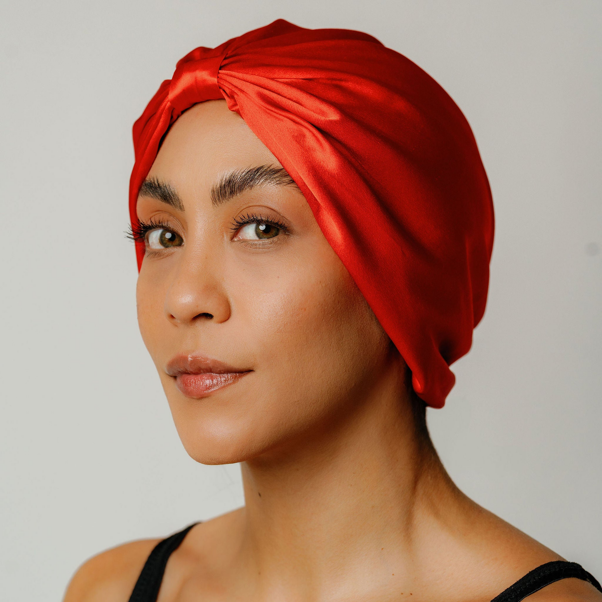 Organic silk hair bonnet in tomato red by LINA LENNOX, featuring a smooth, comfortable design for protecting hair overnight.