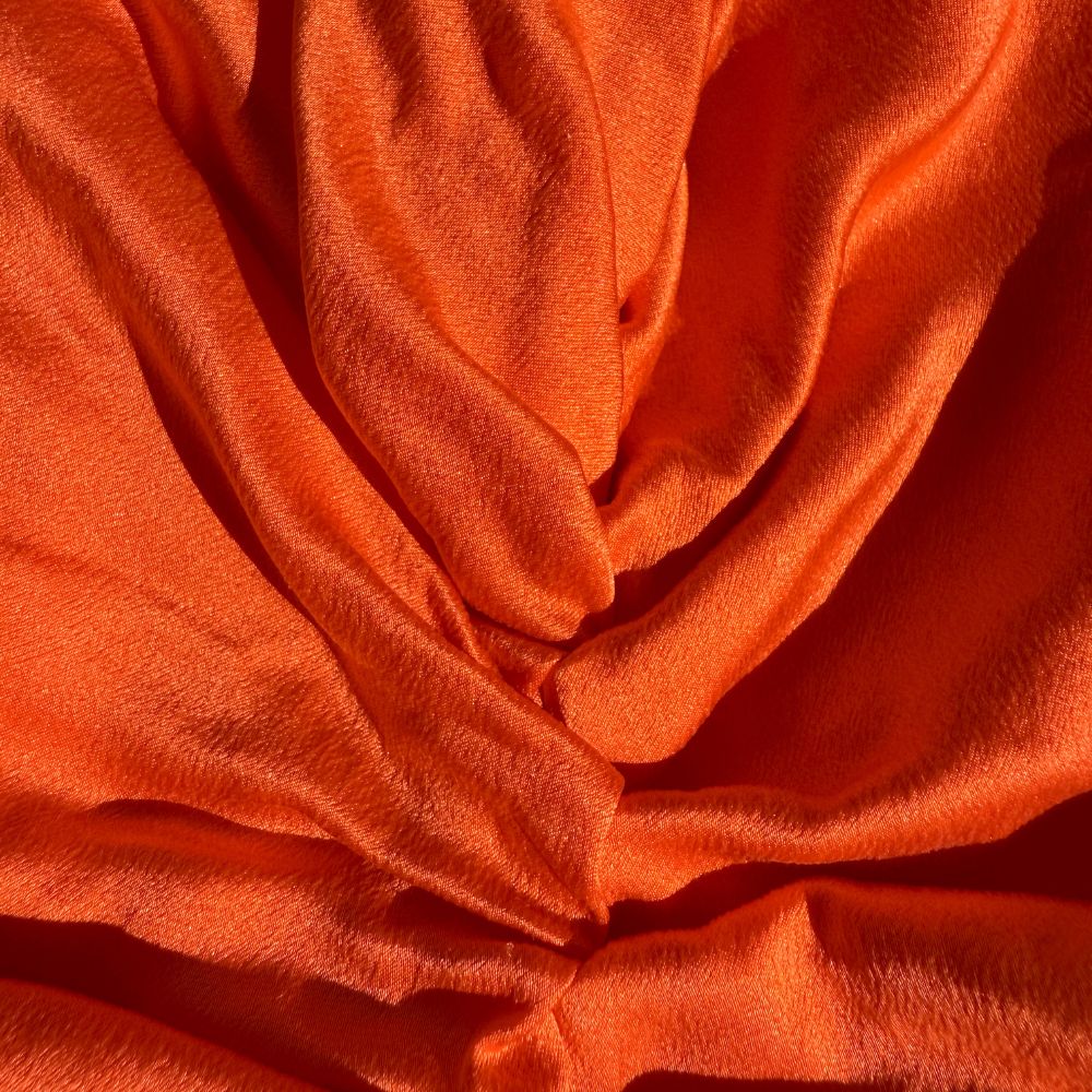 Organic silk hair bonnet in tomato red by LINA LENNOX, featuring a soft, smooth fabric and snug fit for hair protection.