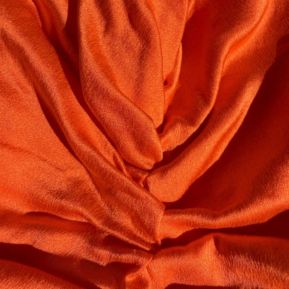 Organic silk hair bonnet in tomato red by LINA LENNOX, featuring a soft, smooth fabric and snug fit for hair protection.