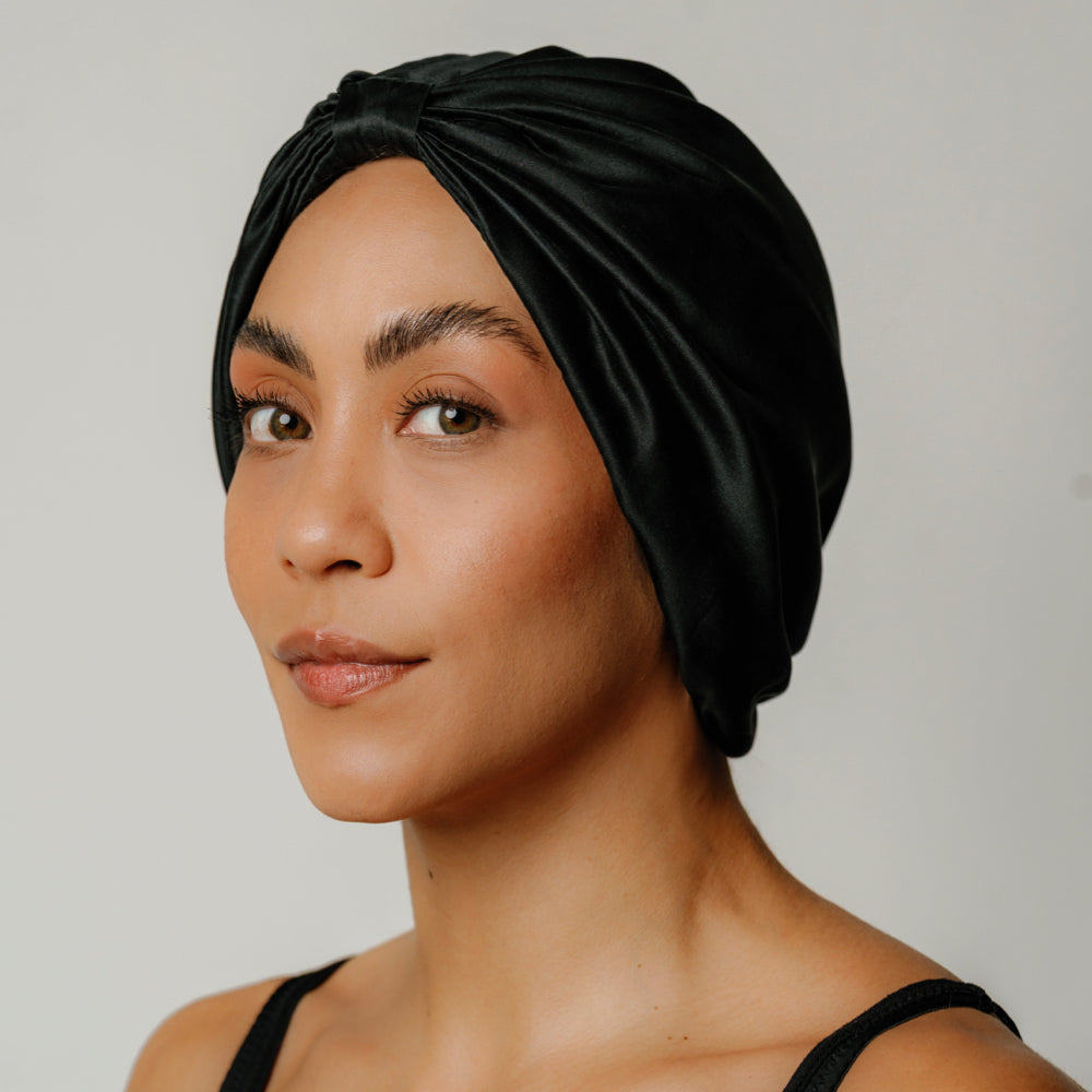 Organic silk hair bonnet in Onyx Black by LINA LENNOX, showing the comfortable, smooth fabric and secure elastic design.