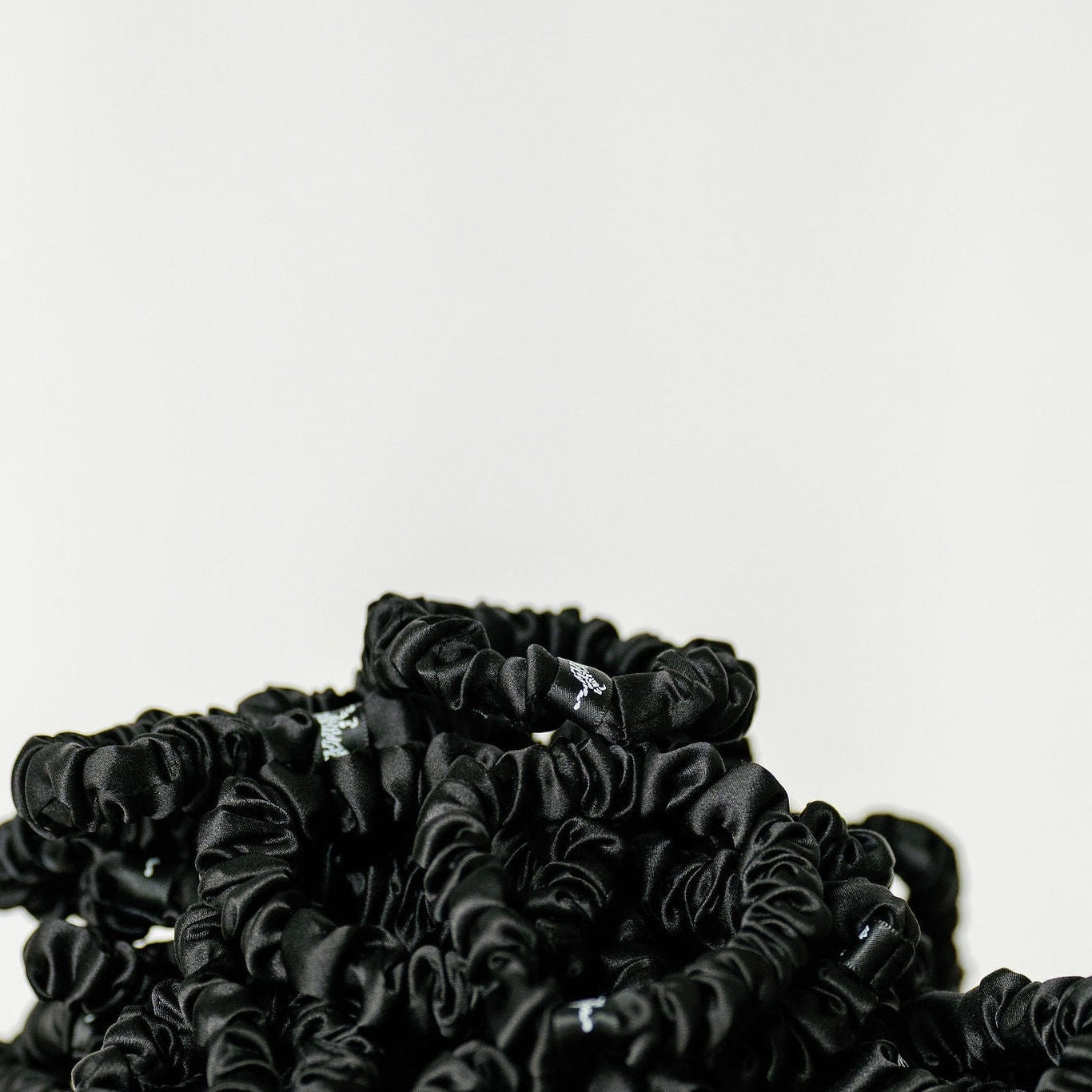 Organic silk small scrunchie by LINA LENNOX in onyx black, soft and smooth for gentle hair styling.