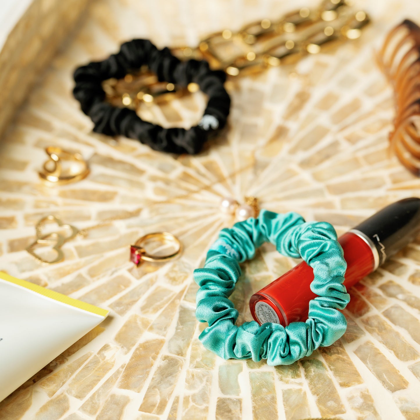 Organic silk small scrunchie by LINA LENNOX in onyx black, featuring smooth, luxurious fabric and a gentle elastic hold.
