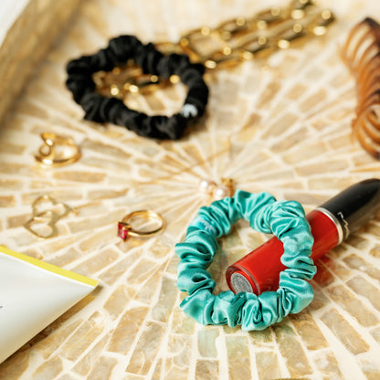 Organic silk small scrunchie by LINA LENNOX in onyx black, featuring smooth, luxurious fabric and a gentle elastic hold.