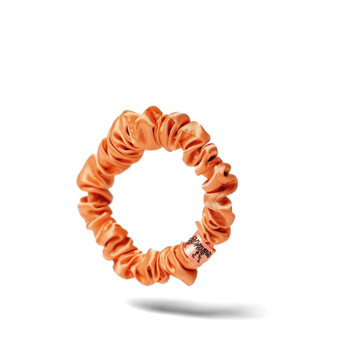 Organic silk small scrunchie in Peachy Coral by LINA LENNOX, featuring soft, luxurious silk fabric and gentle elastic for hair styling.