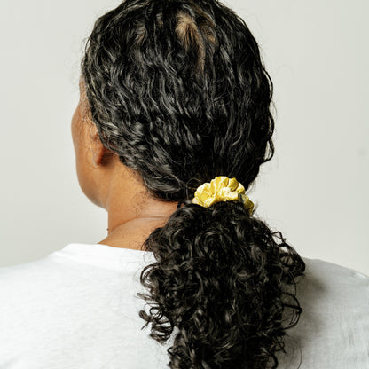 Organic silk small scrunchie in sunshine yellow by LINA LENNOX, featuring a soft, shiny fabric perfect for gentle hair styling.