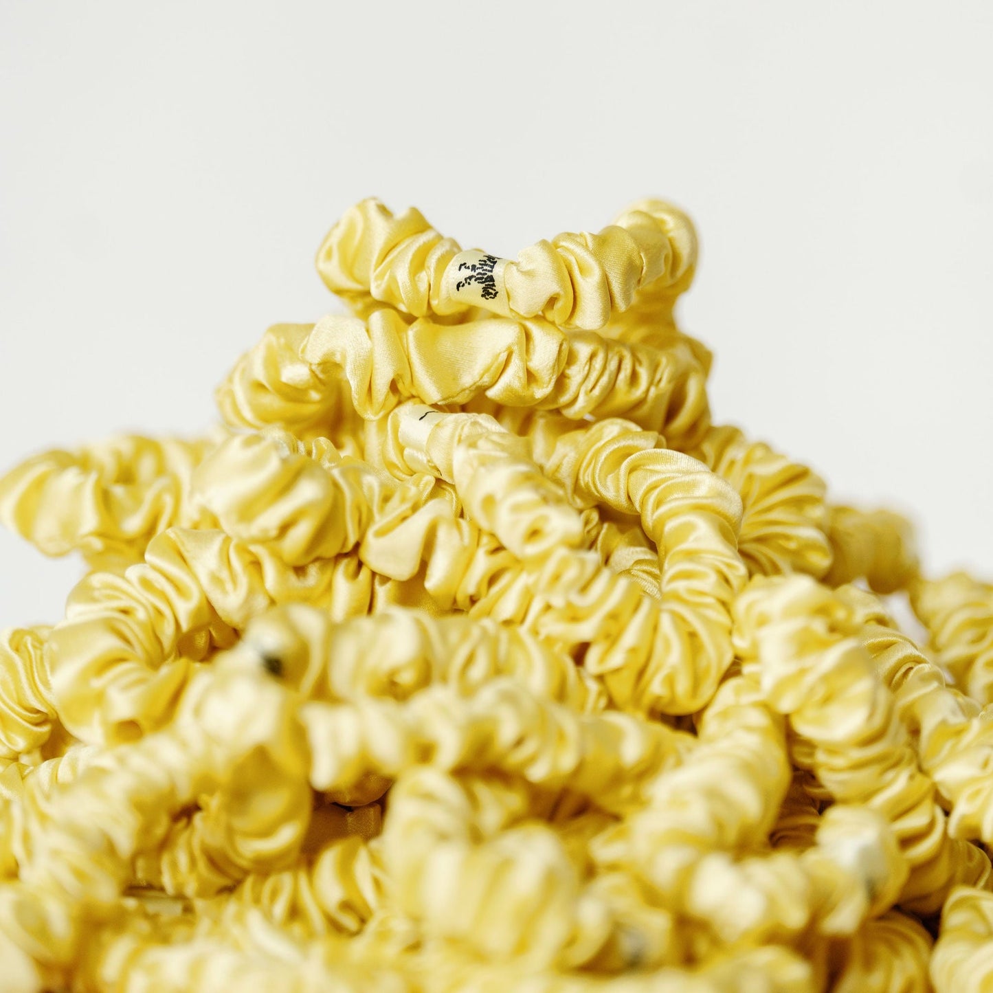 Organic silk small scrunchie in sunshine yellow by LINA LENNOX, soft and lightweight hair accessory with a gentle elastic band.