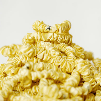 Organic silk small scrunchie in sunshine yellow by LINA LENNOX, soft and lightweight hair accessory with a gentle elastic band.